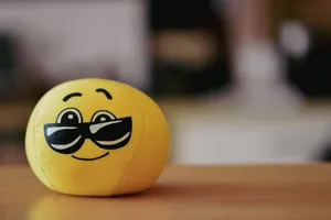A cheerful yellow emoji ball with sunglasses, perfect for playful and fun themes. jigsaw puzzle
