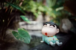 Charming cartoon character figurine relaxing in a peaceful garden setting. jigsaw puzzle