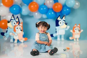 Adorable toddler in a playful cartoon-themed birthday setting with balloons. jigsaw puzzle