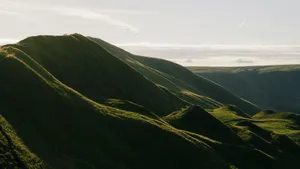 Beautiful green hills with gentle evening light creating serene scenery, perfect nature escape. jigsaw puzzle