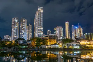 Illuminated skyscrapers reflected on the water, showcasing a vibrant city nightlife. jigsaw puzzle