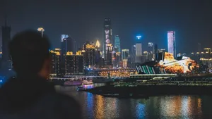 Back view unrecognizable blurred male enjoying amazing view of contemporary illuminated embankment in Chungking China during night jigsaw puzzle