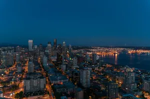 A breathtaking view of Seattle's skyline at twilight with city lights illuminating the urban landscape. jigsaw puzzle