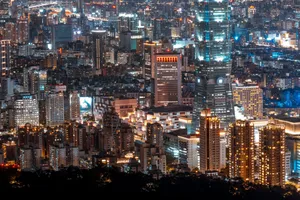 Stunning night view of Taipei's illuminated skyline featuring modern skyscrapers and city lights. jigsaw puzzle