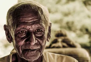 Close-up portrait of a thoughtful elderly man with expressive eyes and weathered skin. jigsaw puzzle