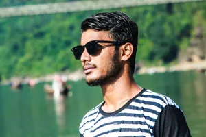 A young man with sunglasses by the river at Jaflong, Bangladesh. jigsaw puzzle