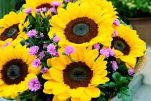 A stunning bouquet of sunflowers and purple flowers, perfect for brightening any space. jigsaw puzzle