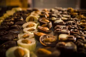 Close-up of assorted handmade gourmet chocolates with almonds set on a display table. jigsaw puzzle