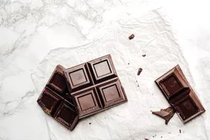 Elegant display of dark chocolate bars on a white marble surface. Perfect for dessert lovers. jigsaw puzzle