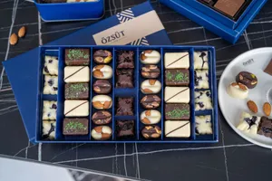 Discover a gourmet assortment of chocolates featuring almonds and pistachios in a stylish blue box from Kahramanmaraş. jigsaw puzzle