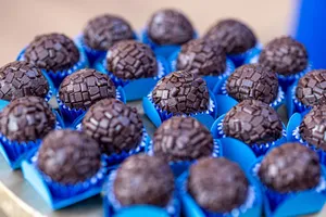 Close-up of handcrafted chocolate brigadeiros in vibrant blue wrappers, perfect for dessert lovers. jigsaw puzzle