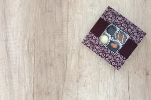 An elegant box of assorted chocolates placed on a rustic wooden table, perfect for a gift. jigsaw puzzle