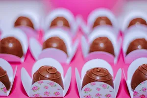 Rows of enticing chocolate truffles elegantly placed in floral wrappers for a celebration. jigsaw puzzle
