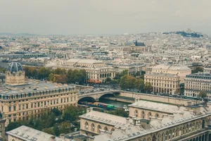 Aerial view of Paris cityscape featuring Seine River and historic architecture under a cloudy sky. jigsaw puzzle