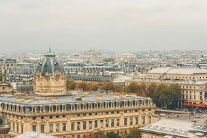 Panoramic view of historic architecture in Paris with a cloudy sky, showcasing iconic urban scenes. jigsaw puzzle