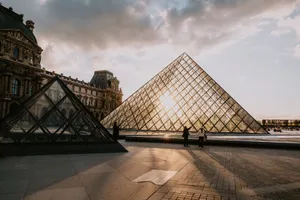 The iconic Louvre Pyramid glows with the sunset in the backdrop of Paris, France. jigsaw puzzle