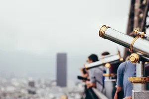 Tourists using telescopes for city view in a cloudy urban outdoor setting. jigsaw puzzle