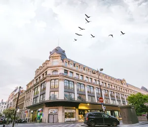A classic city building with birds soaring in the sky, perfect urban aesthetics. jigsaw puzzle
