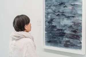 A woman looking at an abstract painting in a modern art gallery. jigsaw puzzle