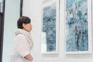 Woman gazing thoughtfully at abstract paintings in a modern art gallery exhibit. jigsaw puzzle