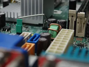 Detailed view of electronic components on a computer motherboard focusing on connectors and capacitors. jigsaw puzzle