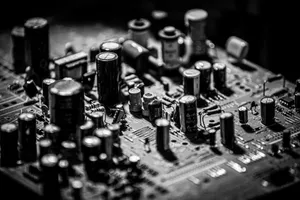 Grayscale close-up of electronic circuit board with capacitors and transistors. jigsaw puzzle