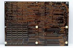Close-up of a retro circuit board showcasing intricate copper traces and electronic components. jigsaw puzzle