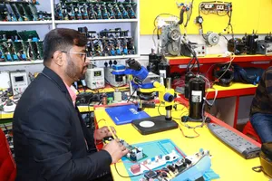 A man in Delhi working in an electronics lab with tools and components. jigsaw puzzle