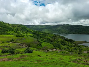 Scenic view of green hills and lake under cloudy skies in Lonavla, MH, India. jigsaw puzzle
