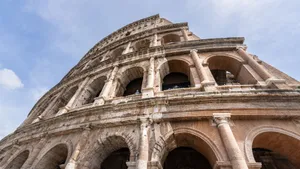 Low angle view of the iconic Colosseum in Rome under a clear sky. jigsaw puzzle