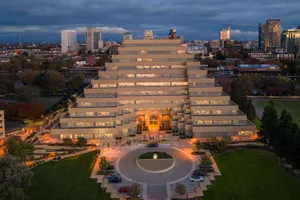 Aerial view of the Ziggurat Building in Sacramento, showcasing its unique architecture at dusk with city skyline background. jigsaw puzzle