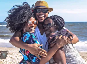 Three friends enjoying a sunny day at the beach, embracing with smiles. jigsaw puzzle