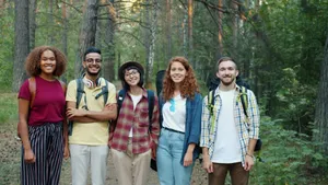 Diverse group of friends smiling and hiking through a lush forest path. jigsaw puzzle
