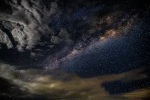 A breathtaking photo capturing the Milky Way galaxy with stars and clouds in a dark, starry sky. jigsaw puzzle