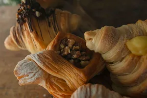 Delicious assortment of flaky pastries including croissants and nut-filled danish. jigsaw puzzle