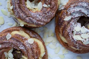 Delicious cream puffs topped with powdered sugar and almond slices. jigsaw puzzle