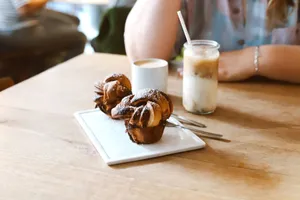 Delicious pastries with coffee and iced latte on a wooden table in a Berlin café. jigsaw puzzle