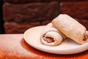 Delicious apple jam-filled cookies with powdered sugar on a plate, perfect for dessert. jigsaw puzzle