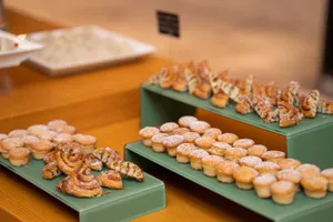 Delicious assortment of mini pastries beautifully displayed at a bakery. Perfect for a sweet indulgence. jigsaw puzzle
