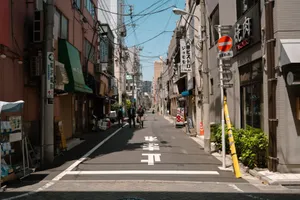 A quiet street in Tokyo, showcasing urban life and traditional architecture on a sunny day. jigsaw puzzle