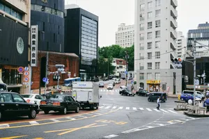 A bustling city street scene at a busy intersection with traffic and pedestrians. jigsaw puzzle