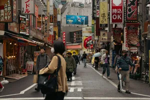Bustling street in Tokyo with diverse pedestrians and vibrant signs capturing urban life. jigsaw puzzle