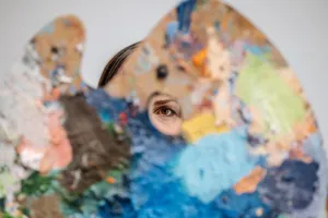 An eye peers through a vibrant artist's palette, symbolizing creativity and art exploration. jigsaw puzzle