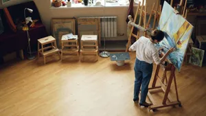A woman painting on a canvas in a well-lit artist studio filled with creative supplies. jigsaw puzzle