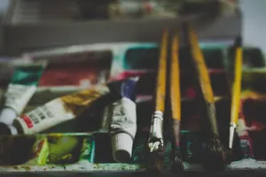 Close-up of paintbrushes and watercolor tubes on a palette, creating a creative and inspiring art scene. jigsaw puzzle