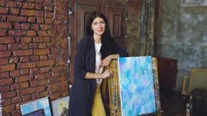 A woman artist in a rustic studio with a colorful painting on an easel. jigsaw puzzle