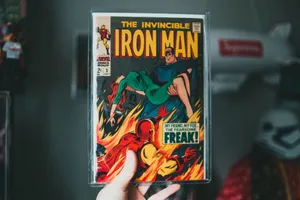 Vintage Iron Man comic book held by hand, showcasing iconic superhero imagery. jigsaw puzzle
