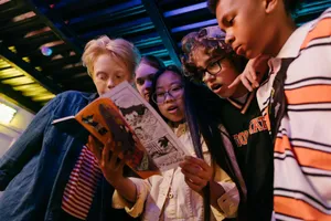 Group of diverse teenagers reading a comic book indoors, showcasing friendship and excitement. jigsaw puzzle