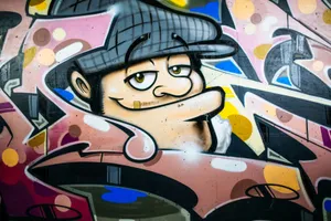 Vibrant street art mural featuring a whimsical character spray-painted on a city wall. jigsaw puzzle