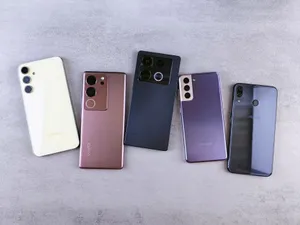Flat lay of five modern smartphones on a gray surface, showcasing various designs. jigsaw puzzle
